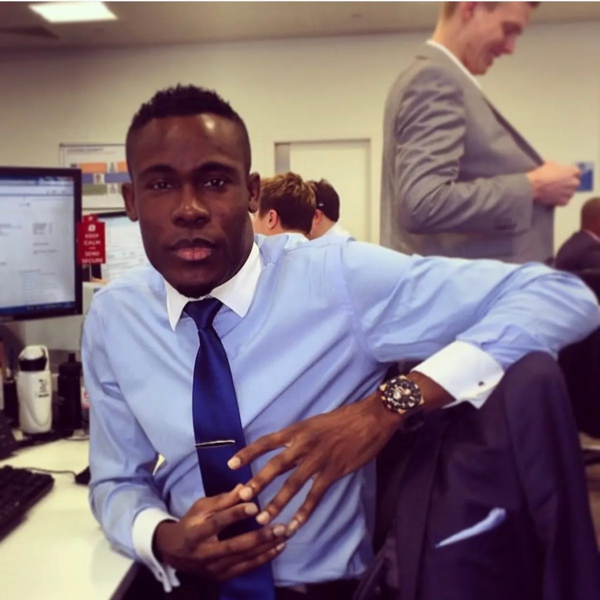 Peter at his desk in an office, in a shirt and tie